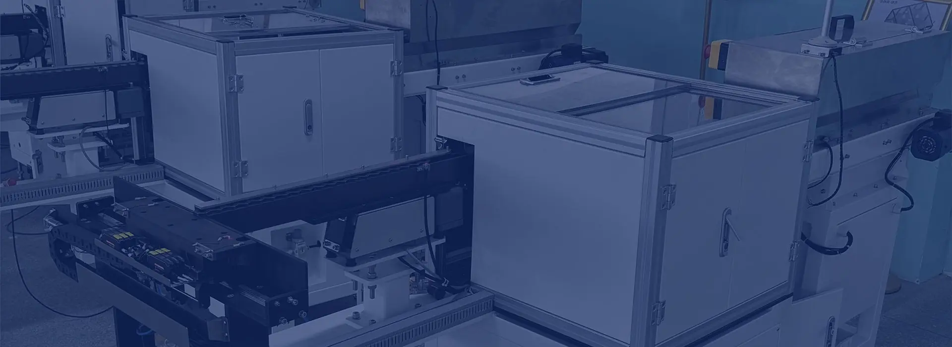 Enclosed feeding equipment with linear tracks and control panels.