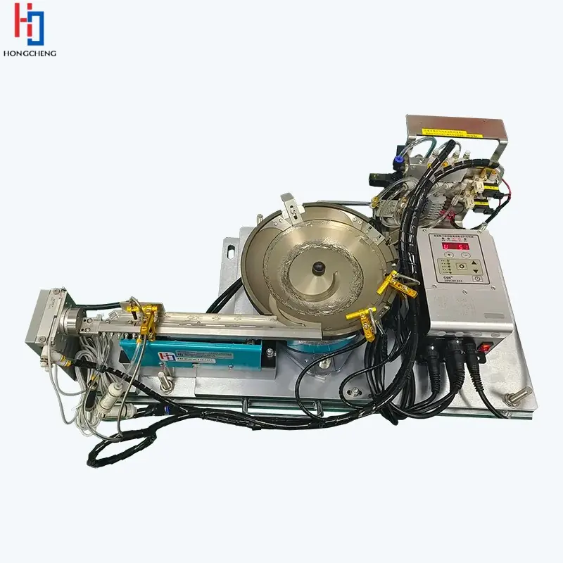 Metal bowl feeder with linear outfeed tooling, wiring and a control unit.